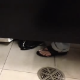 Someone records a woman in a public restroom making some overly dramatic grunting and sighing sounds while taking a shit. No poop action visible.